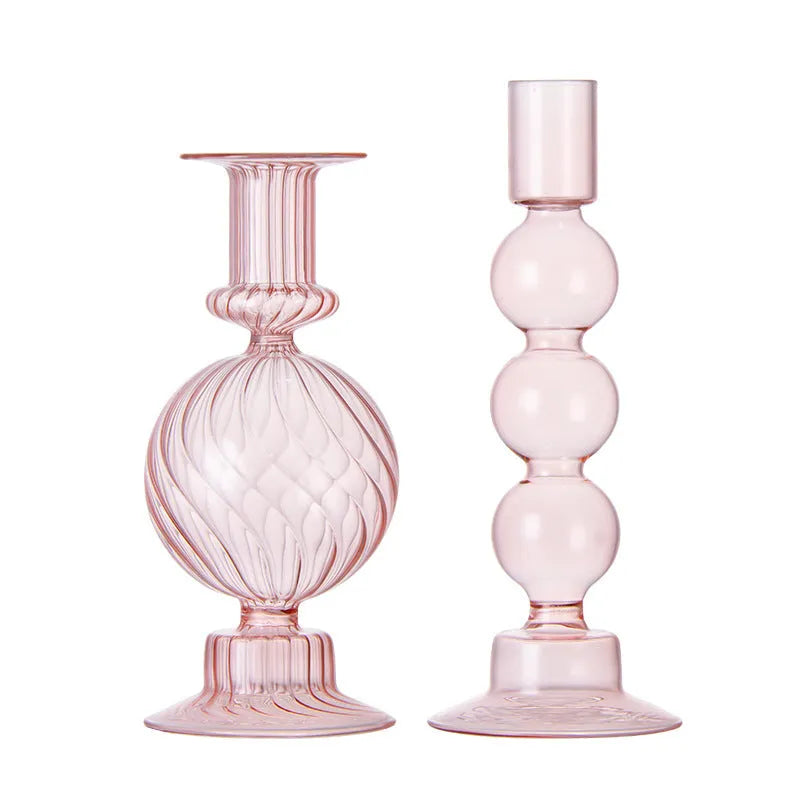 Transparent borosilicate glass three ball mott candle holder in green on a table