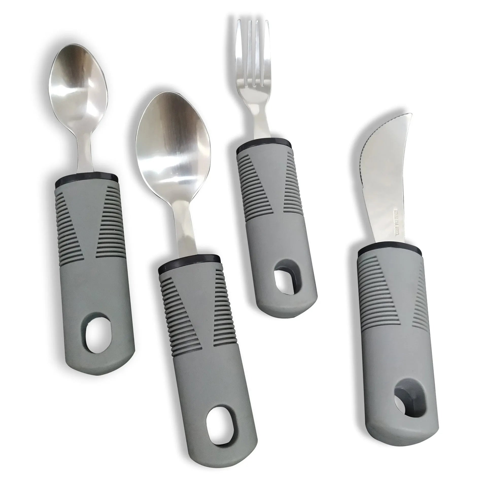 Stainless steel adaptive knife, fork, and spoon set with black rubber handles on a table.