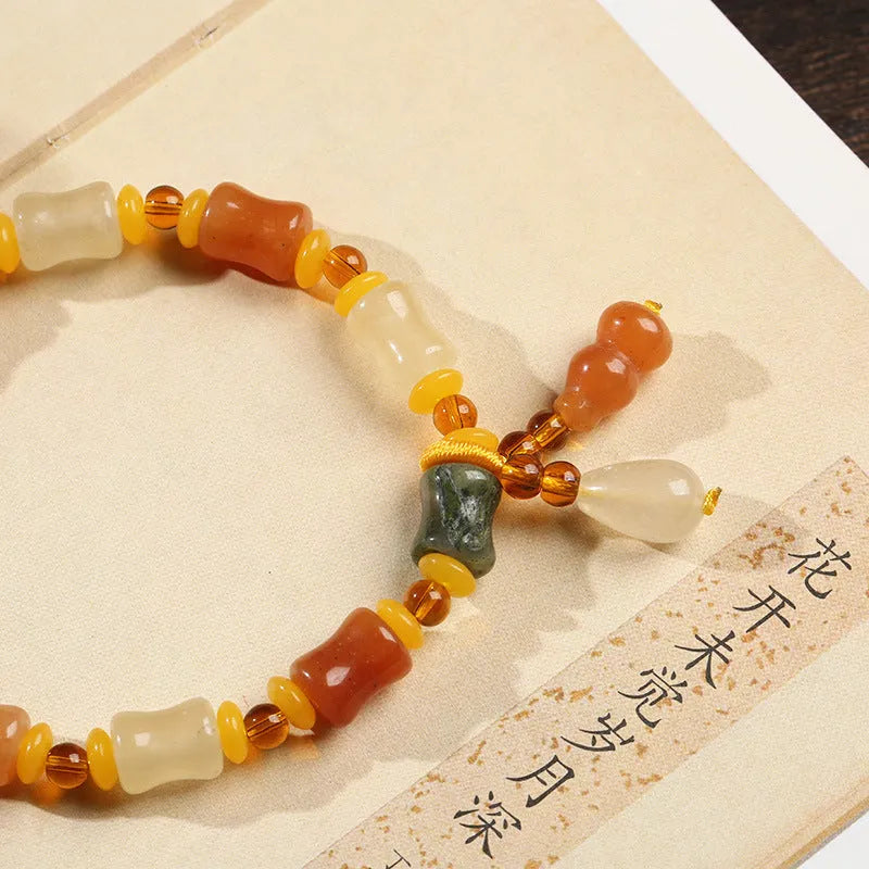 Jinsi Jade bracelet with small bone beads showing auspicious patterns and geometric design