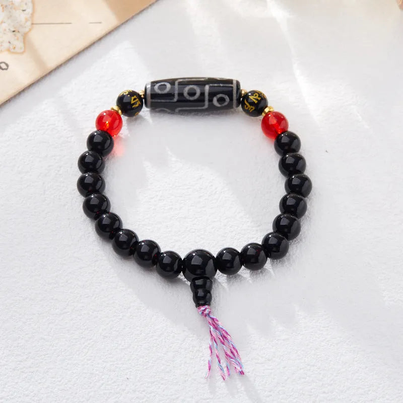 8mm agate Dzi bead bracelet with geometric shape and Tibetan-style beaded strap.