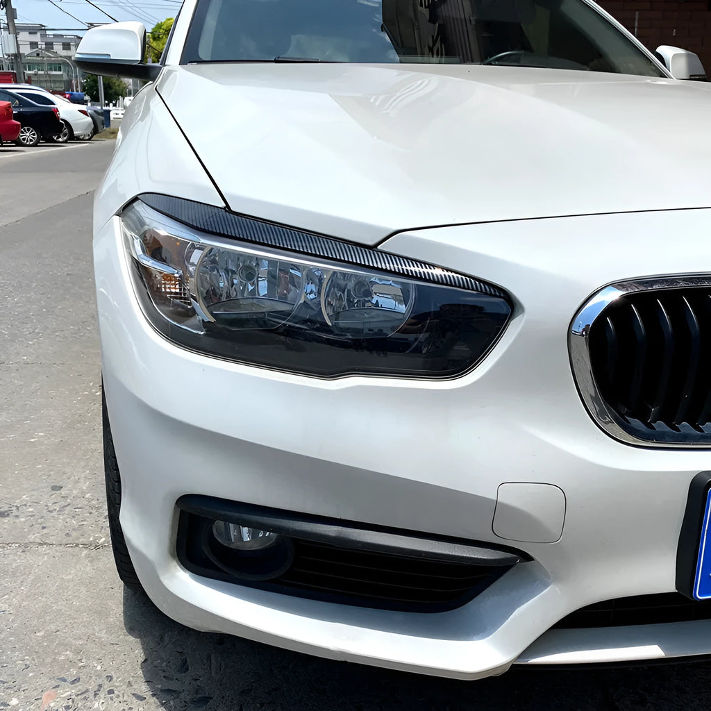 Pair of ABS headlight eyebrow stickers for BMW 1 Series F20, piano black finish, 48x8x8 cm