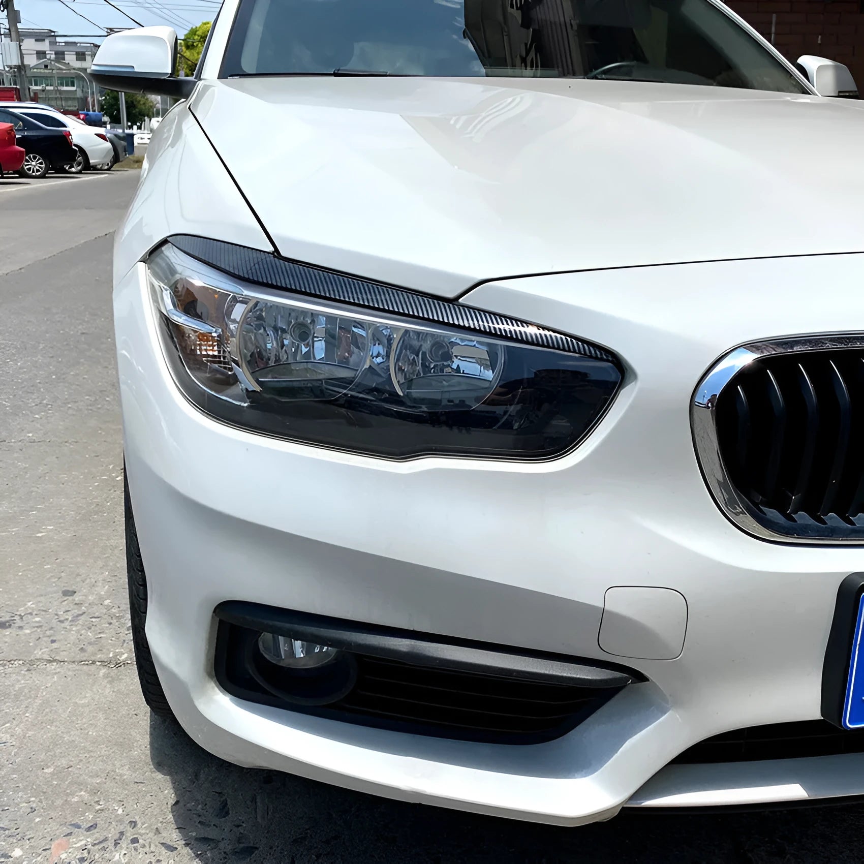 Pair of ABS headlight eyebrow stickers for BMW 1 Series F20, piano black finish, 48x8x8 cm