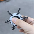 Colourful stickman running dynamic fingertip gyro on a white surface, spinning motion visible