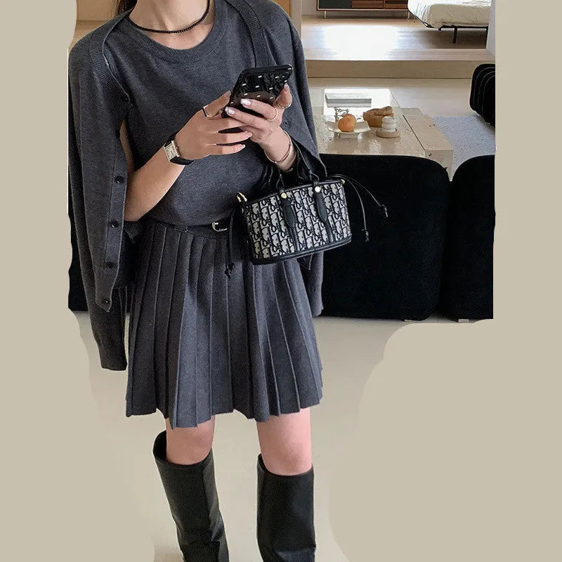 Grey art retro women's knitted cardigan and pleated vest skirt set with a waist belt.