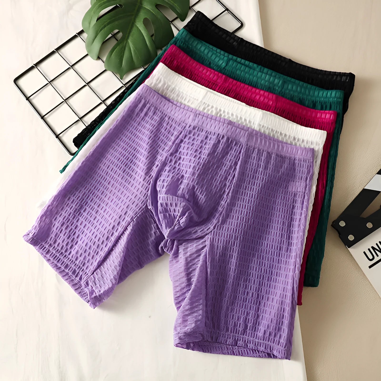 Men's white lace boxer shorts with lengthened hip lifting shaping design on a neutral background