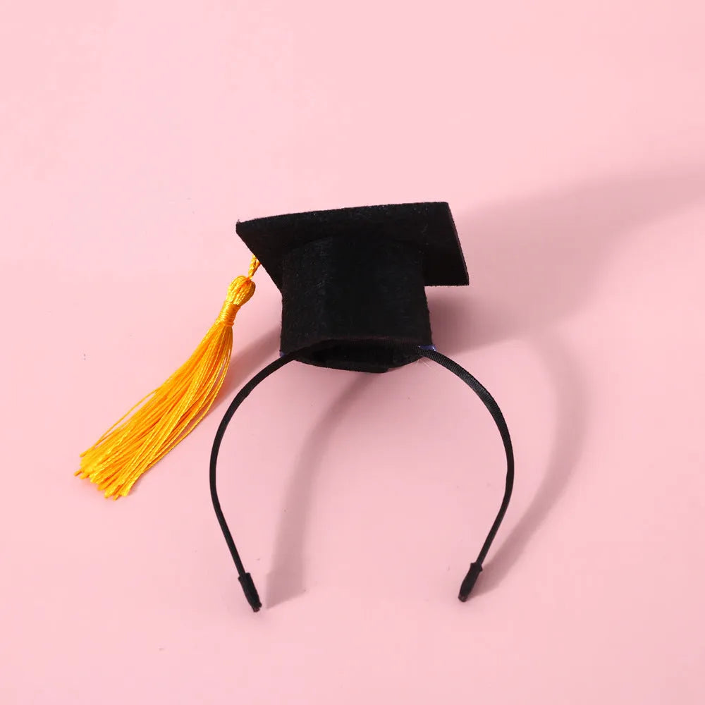 Small pet wearing a woolen felt doctor's degree hair band with a red cap bow tie attached