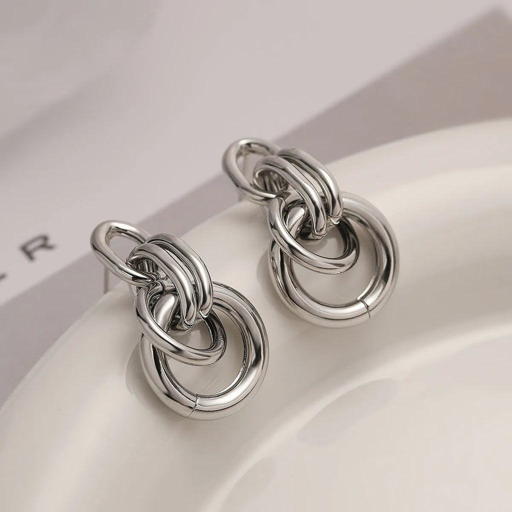 A pair of gold geometric earrings for women with an irregular shape, made from copper.