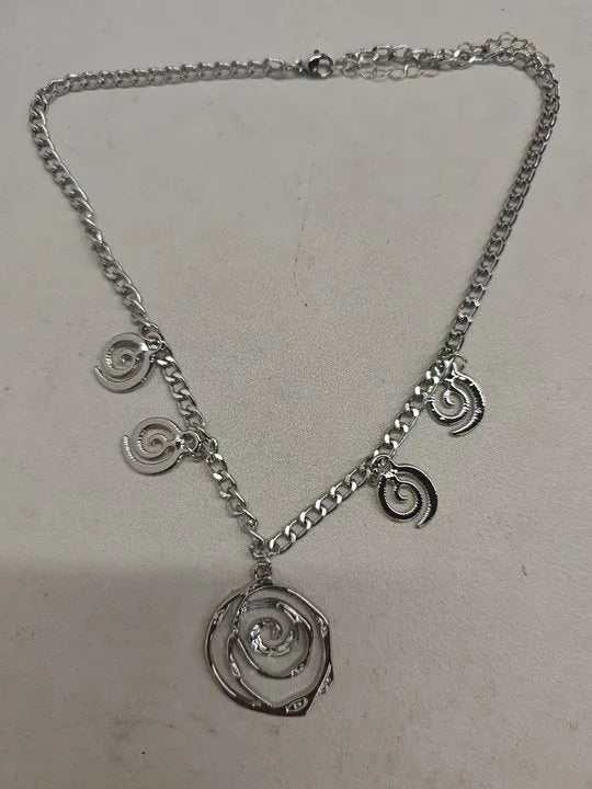 Spiral donut jewellery set showing necklace, bracelet and ear hooks in gold or silver geometric circle design