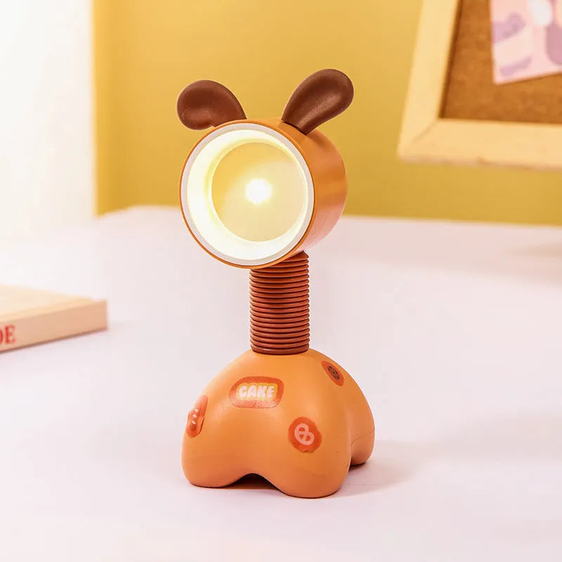 DIY cartoon animal small night lamp with magnetic base in assorted colours on a desk.