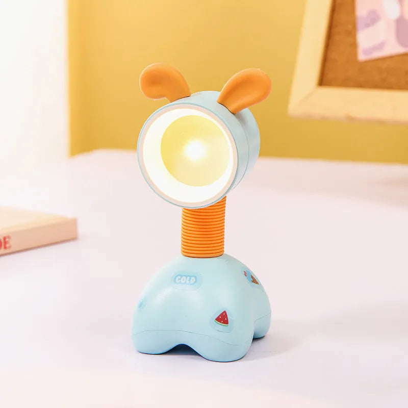 DIY cartoon animal small night lamp with magnetic base in assorted colours on a desk.