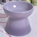 Black chin-high foot ceramic pet bowl for dogs and cats on a flat surface.