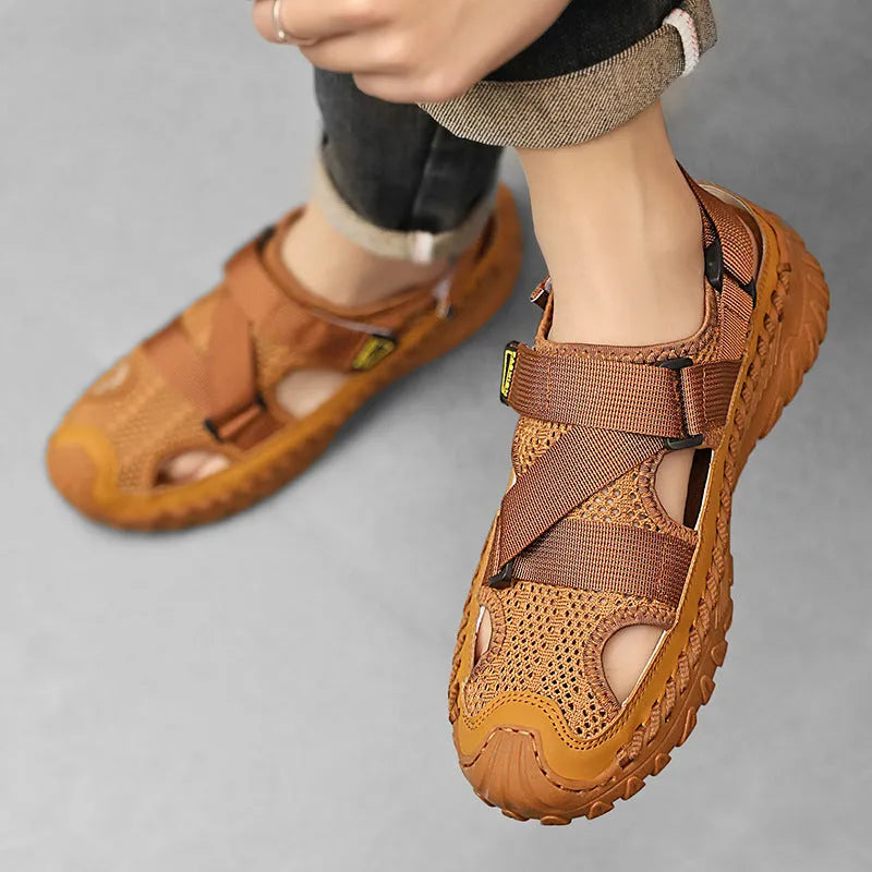 Men's grey genuine leather sandals with mesh lining and an elastic band on a rubber sole.