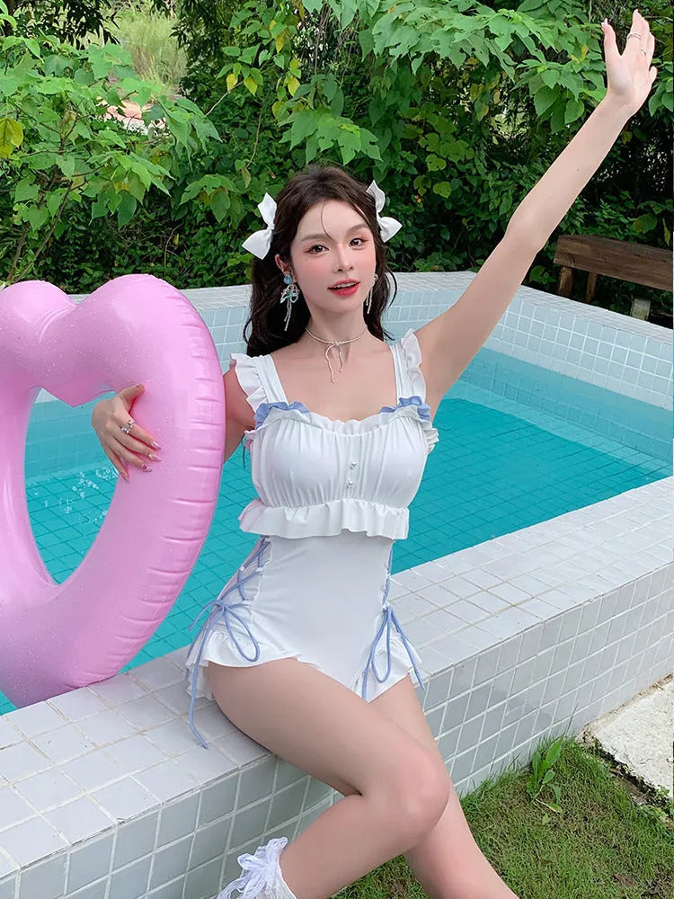 Milky white backless one-piece swimsuit for women on a mannequin.