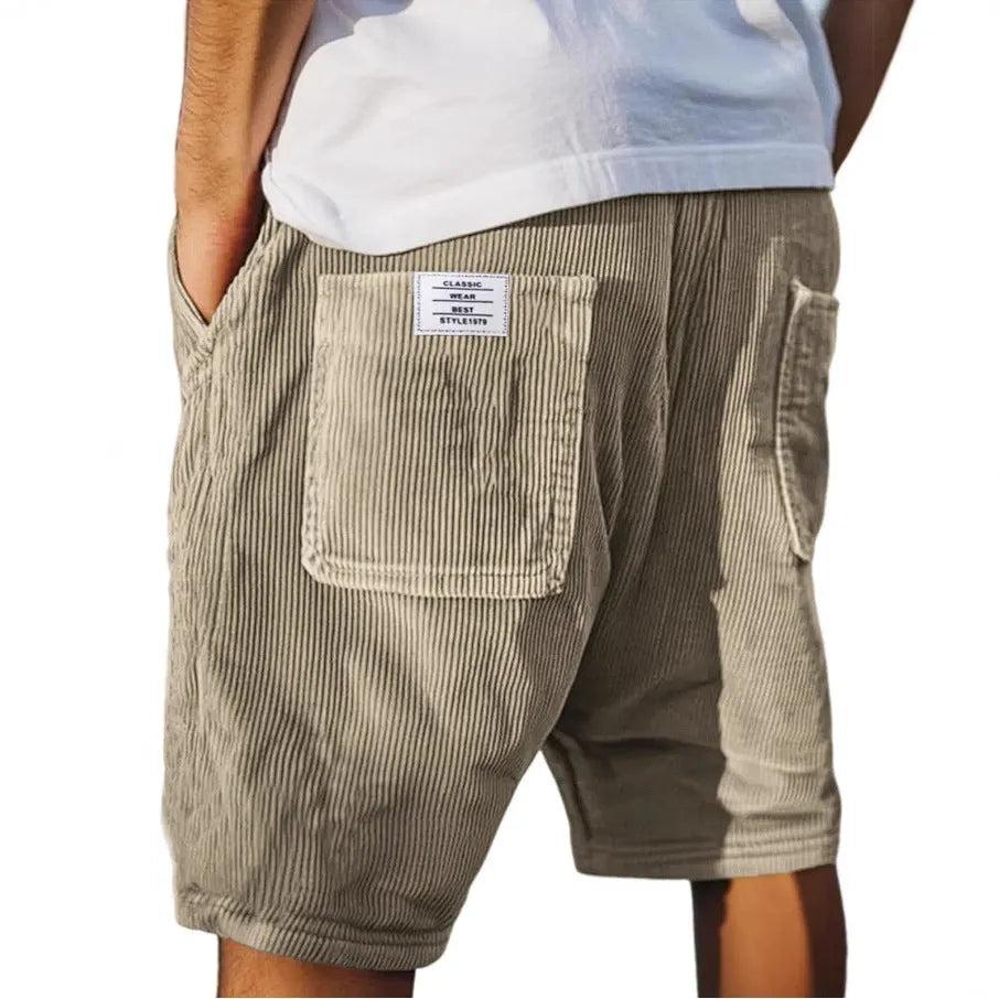 Men's grey straight-fit corduroy shorts with multiple pockets and a small embroidered logo on the leg.