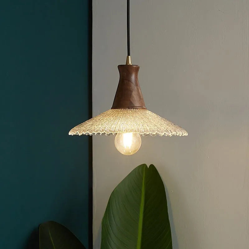Wood and brass ceiling chandelier with glass lampshade in three available sizes.