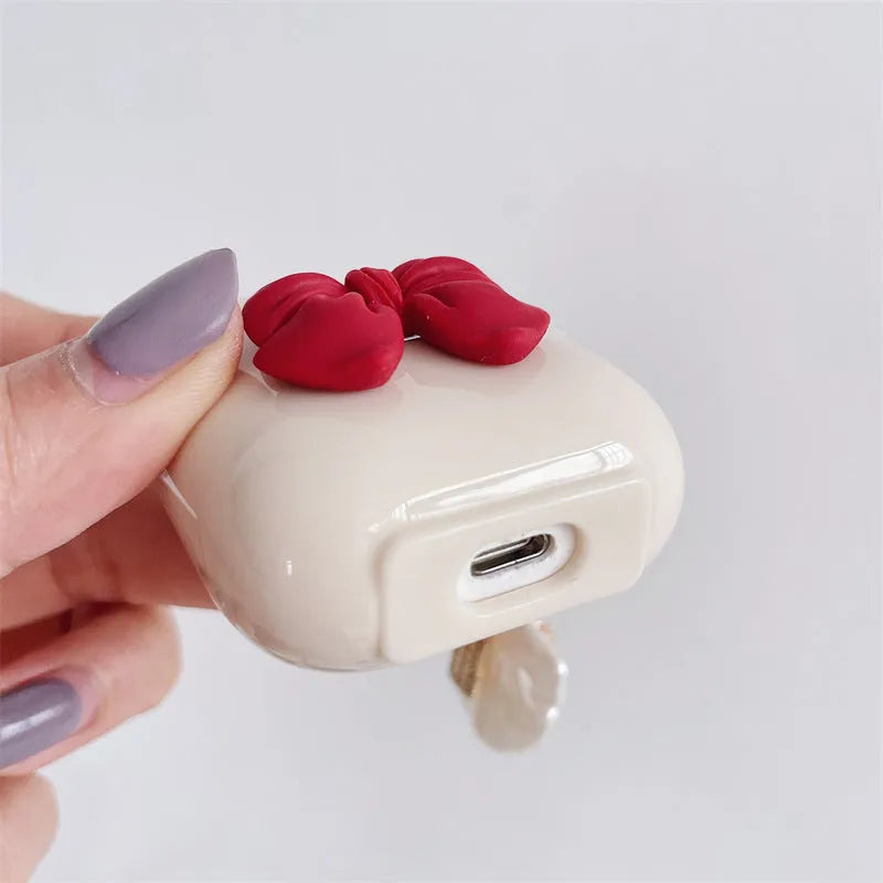 Beige red bow shell TPU protective case cover for AirPods showing clamshell design