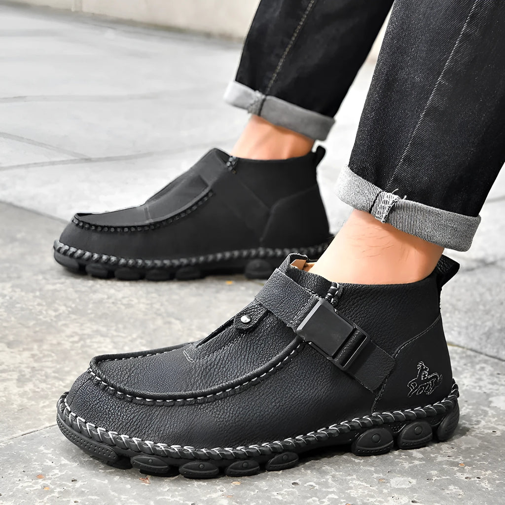 Black handmade stitching flat bottom slip on lazy shoes with low heel on a plain background