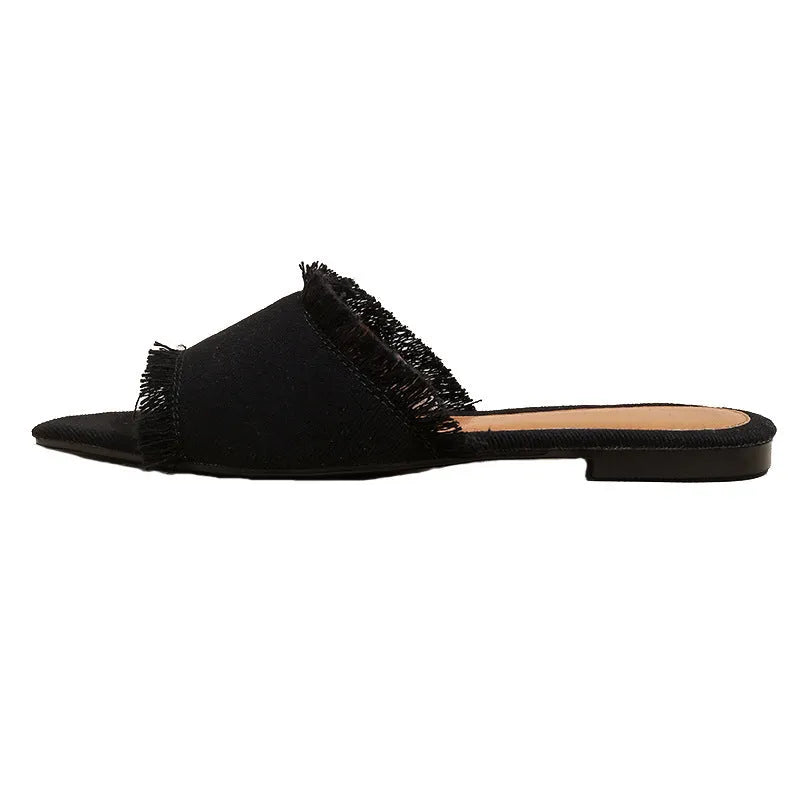 Women's denim flat slippers with a tassel decoration and leather lining in multiple colour options.