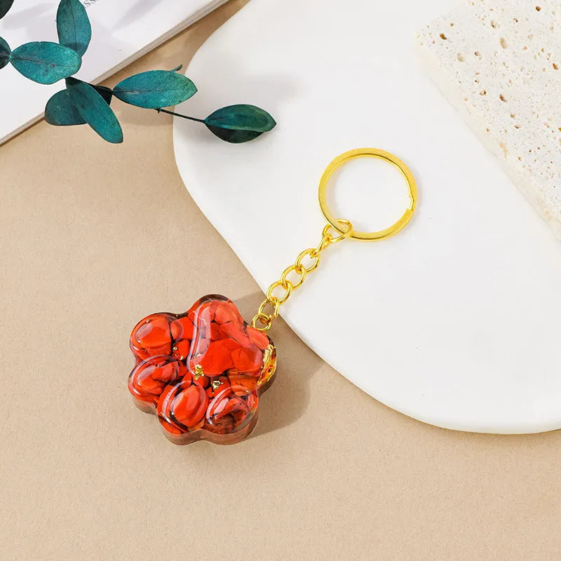 Small natural crystal cat's paw claw charm on a metal loop keychain