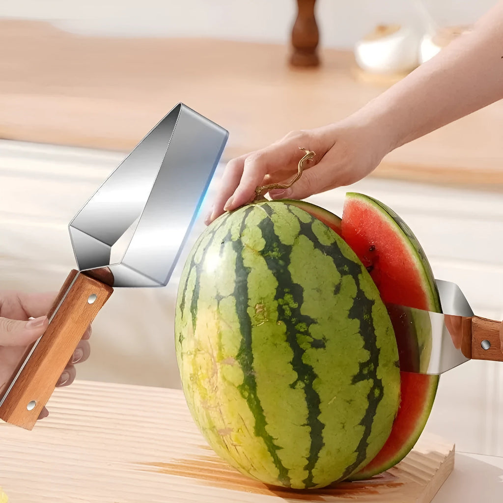 Stainless steel watermelon splitter with triangle cutting piece and protective cover on a kitchen counter.