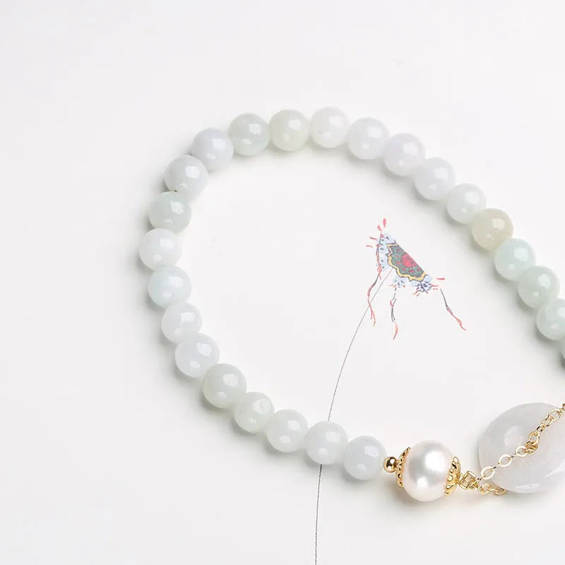 Natural jade bracelet with peace buckle fastener and white pearl accents, geometric pendant design