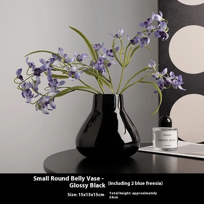 Ceramic decorative vase with artificial flowers in black or white modern design