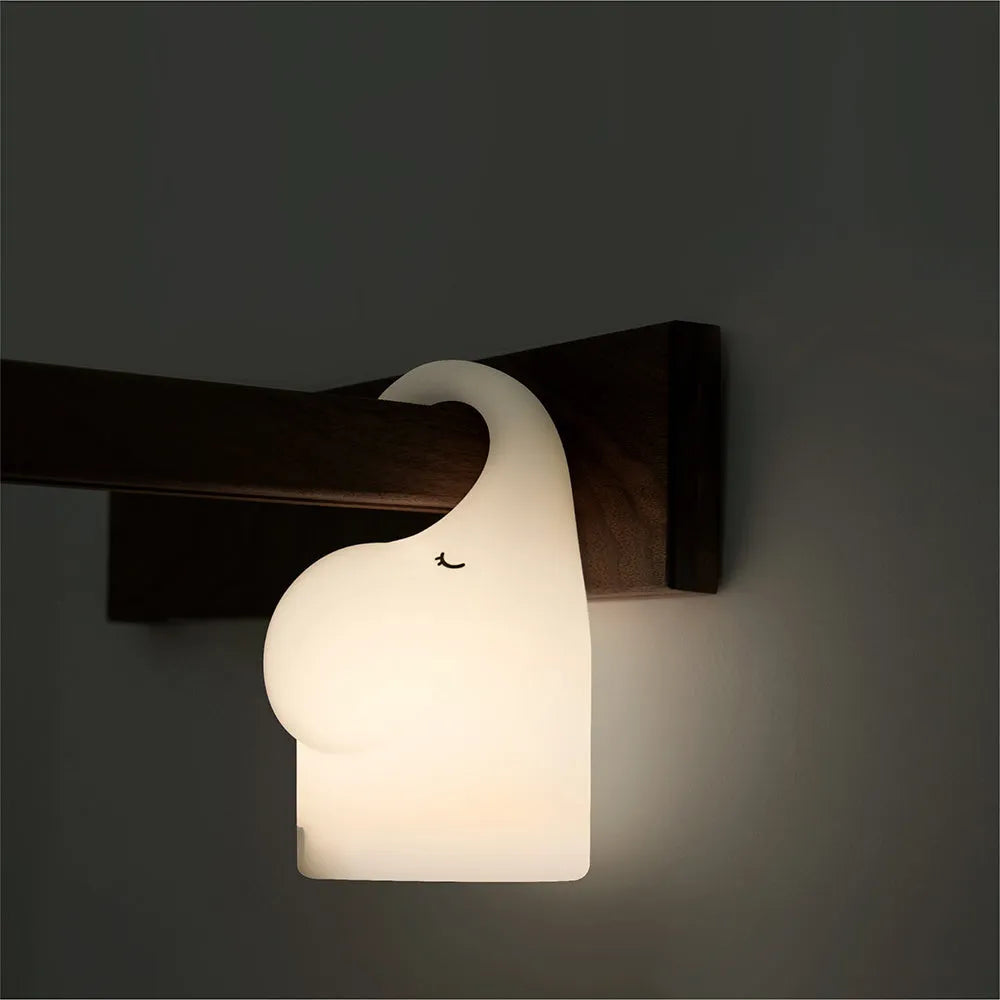 DOMI Elephant silicone night light with warm white glow on bedside table