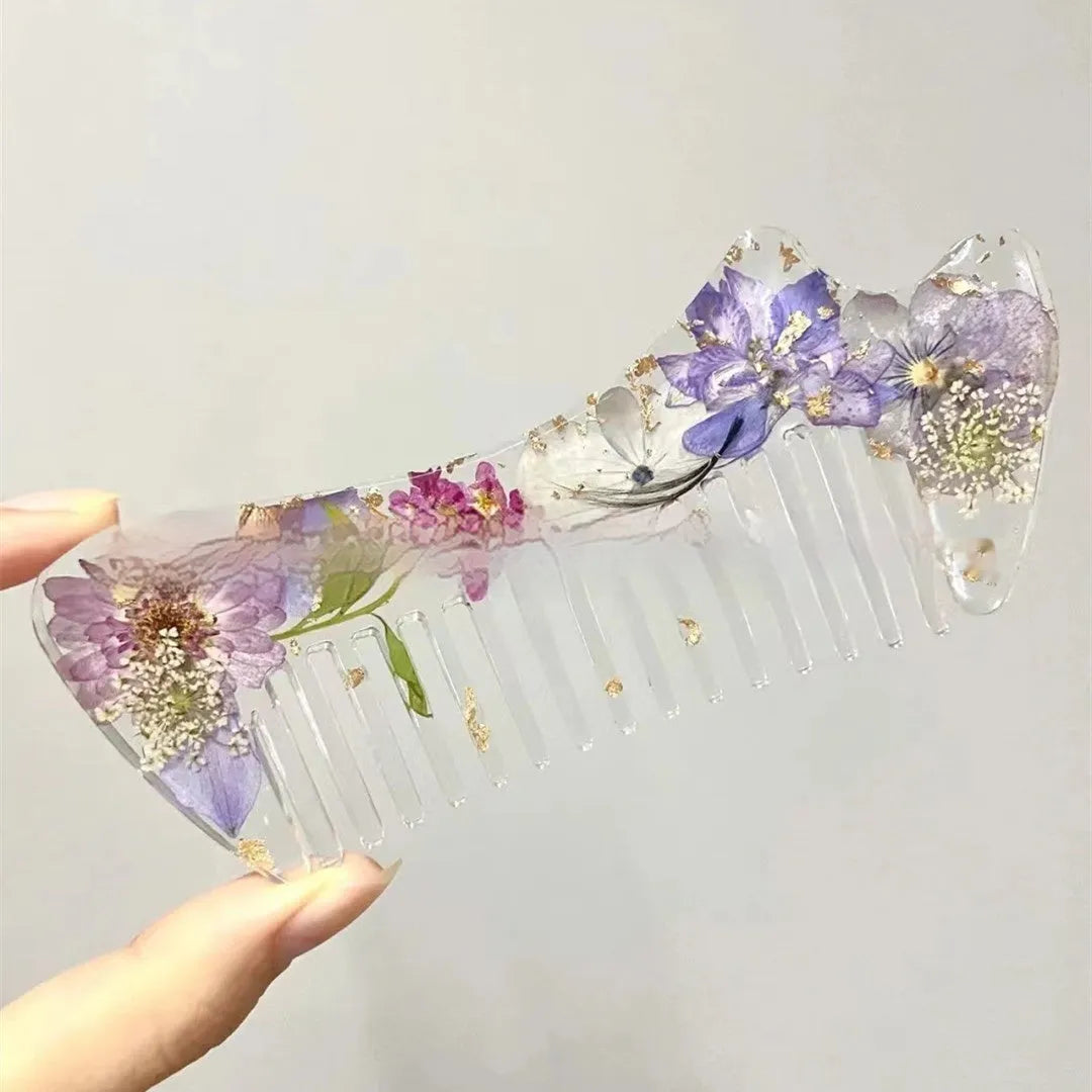 Small glossy resin hair comb with a reflective mirror finish, shown in one of three colour options.