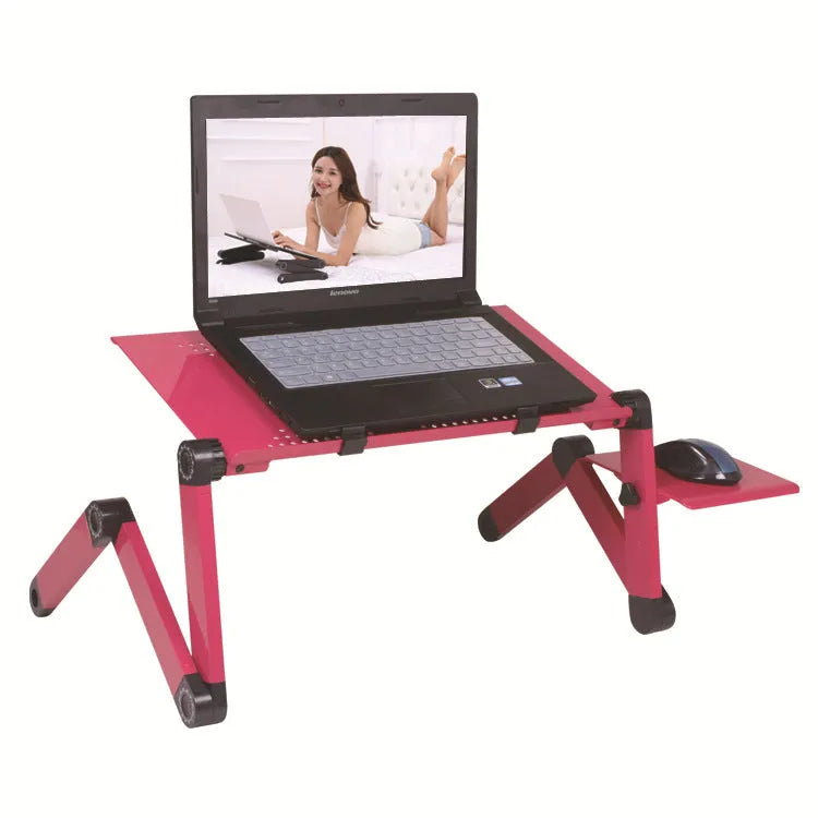 Red folding metal computer desk with cooling holes and mouse board on bed