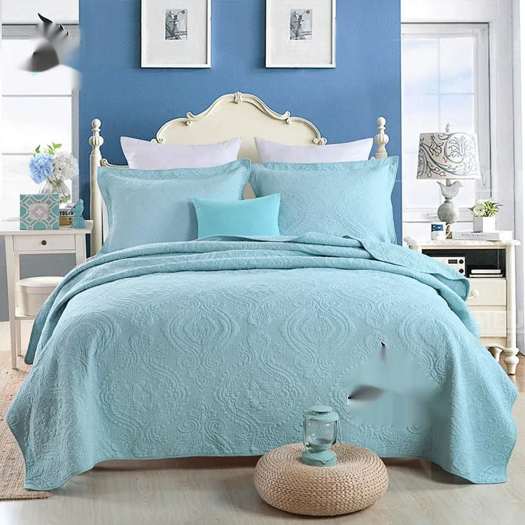 Pure cotton double-sided bed cover three-piece set in a plain colour laid on a bed.