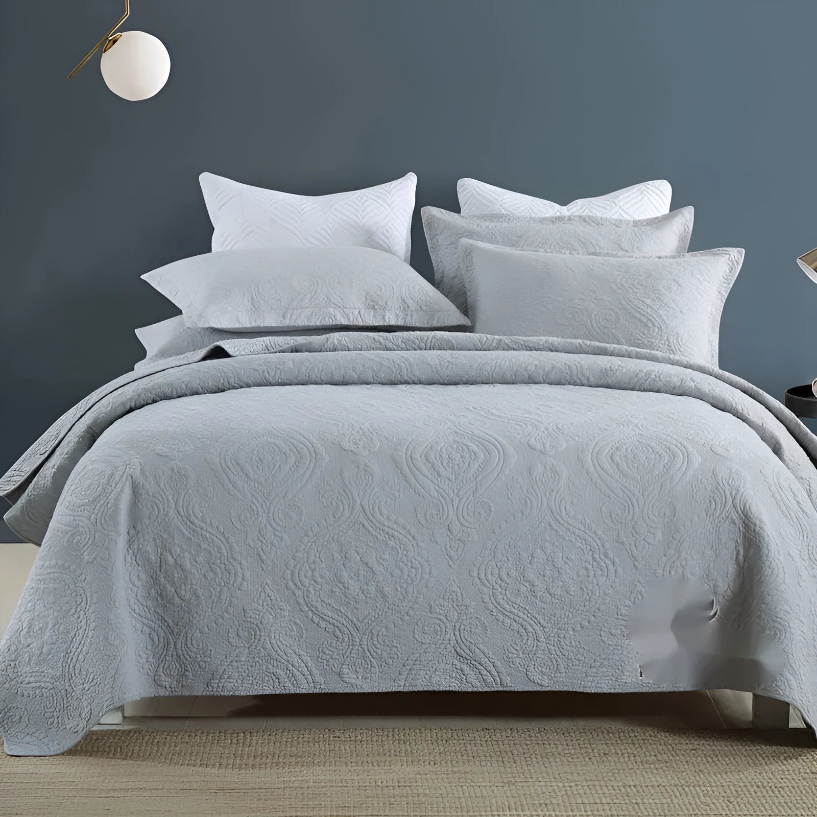 Pure cotton double-sided bed cover three-piece set in a plain colour laid on a bed.