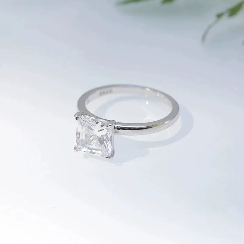 Simple geometric 925 silver ring for women in polished gold, rose gold, or silver finish on a grey background.
