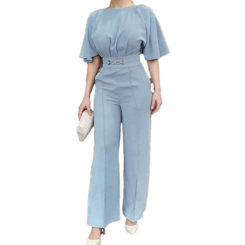 Blue two-piece polyester suit with long sleeves and trousers on a hanger