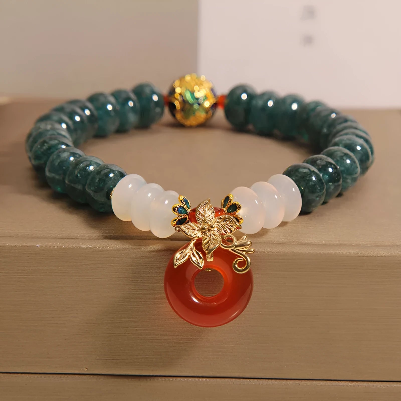Blue water jade and red agate bracelet with peace buckle charm and rhinestone details