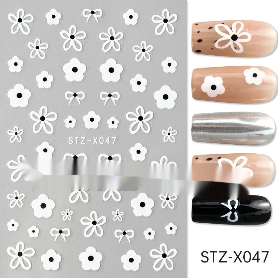 Pack of black and silver strip nail art stickers with cartoon and love pattern designs.