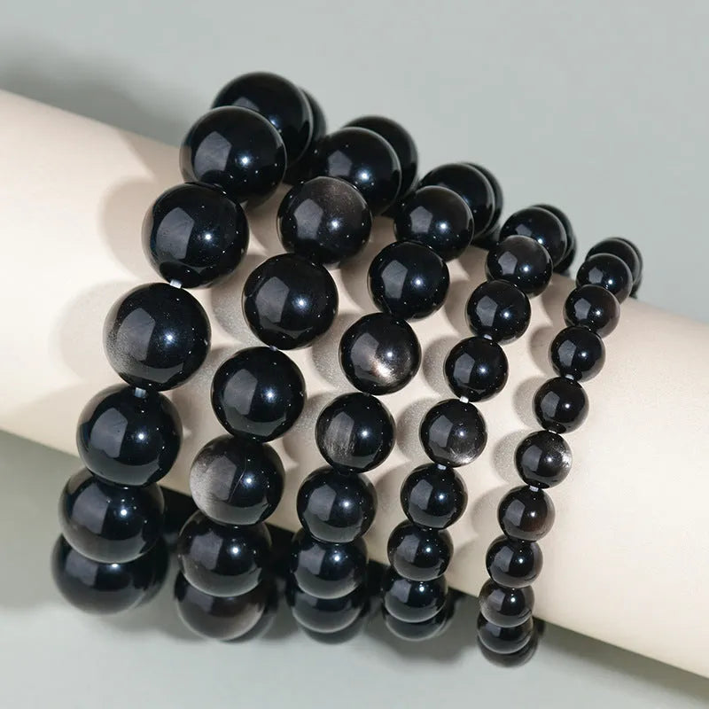 Hand-woven obsidian couple bracelet with year of birth symbols in ethnic style design