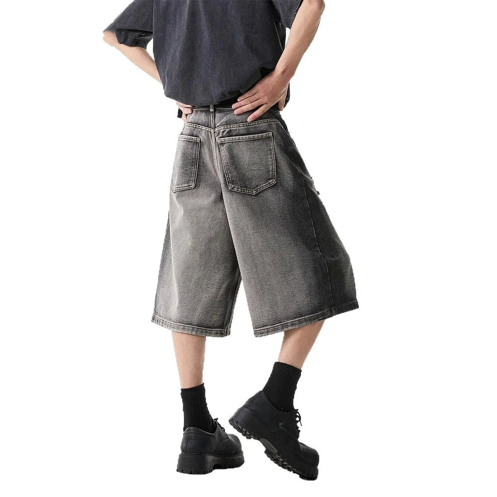 Grey water washed hole denim shorts with loose fit and cropped length on hanger