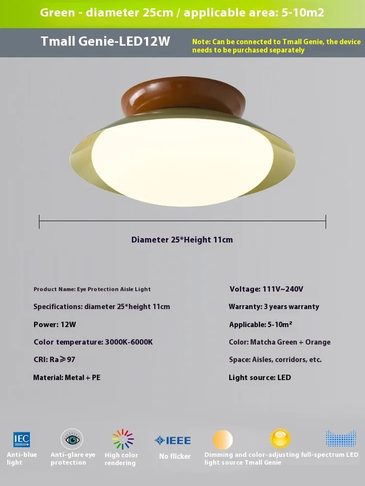 Modern minimalist cream style flying saucer ceiling lamp in mint green on a white ceiling.