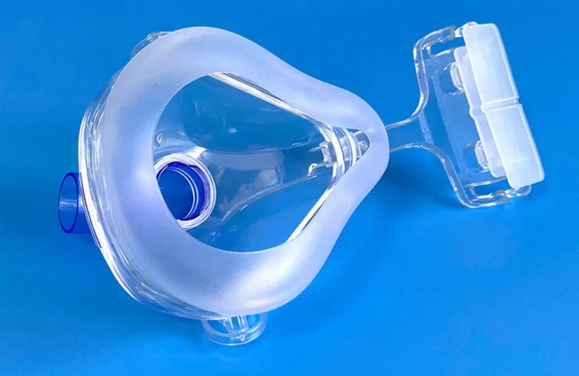 CPAP breathing mask kit with transparent silicone mask, headband, and two PC adapter elbows.