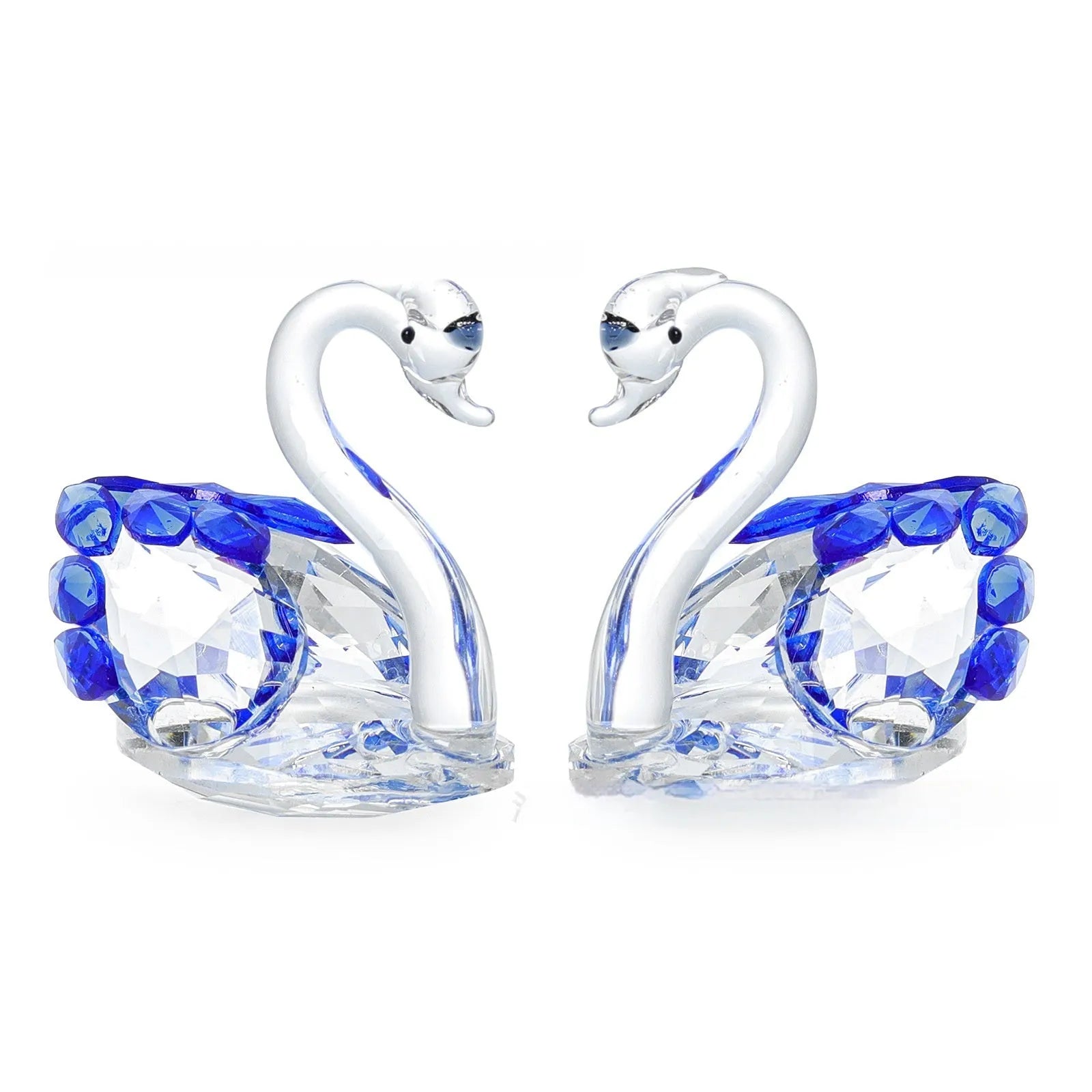 White crystal swan decoration on a desktop in solid head and empty tube styles.