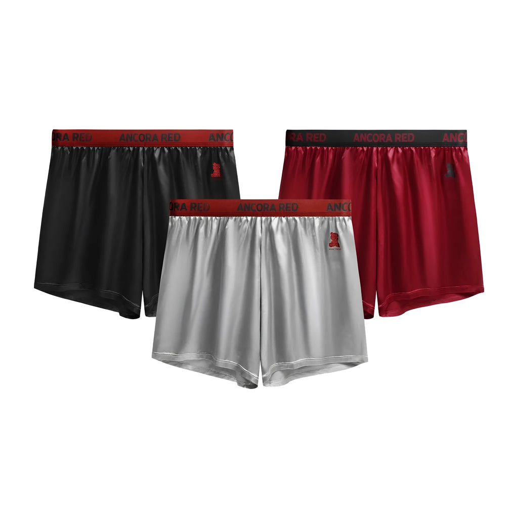 Men's solid colour boxer briefs in black, blue, brown, purple, red, and silver with elastic mid waist