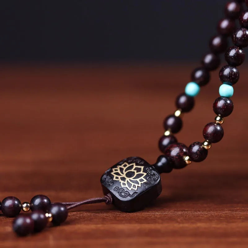 Zambia rosewood DIY bead bracelet with flat lotus pendant ornament on wooden surface