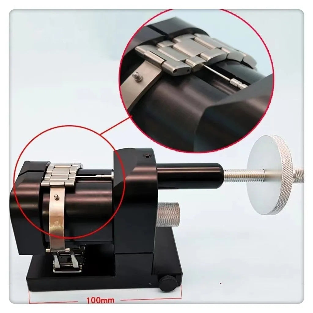Steel alloy watch bracelet pin removal tool machine on a workshop bench.
