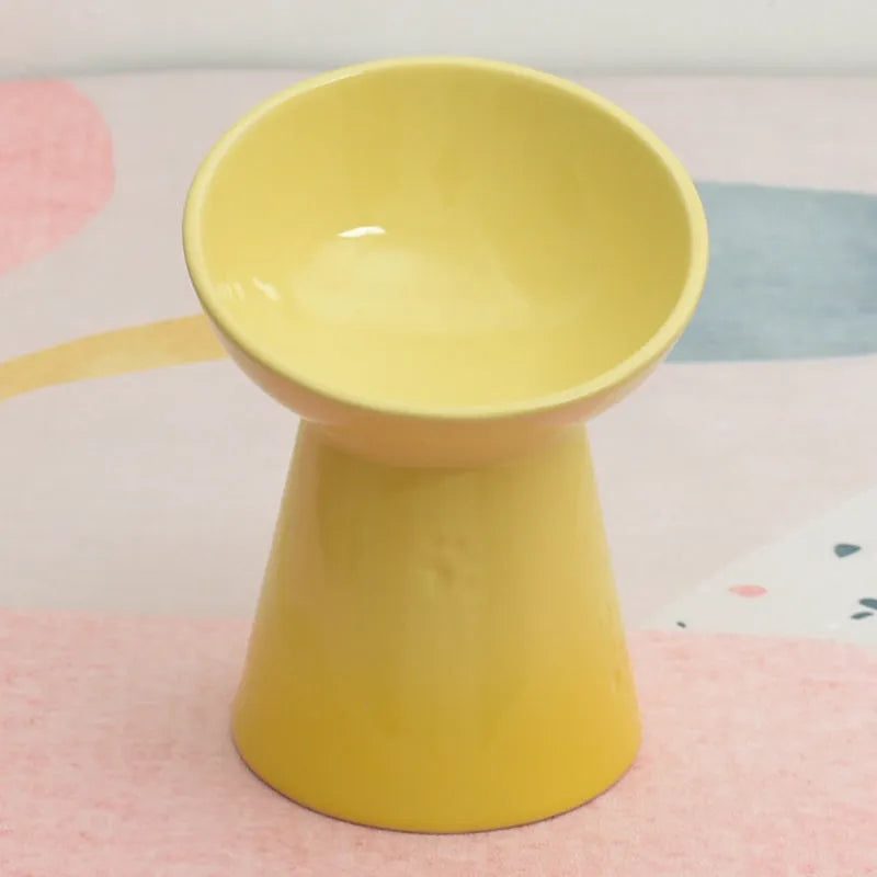 Black chin-high foot ceramic pet bowl for dogs and cats on a flat surface.