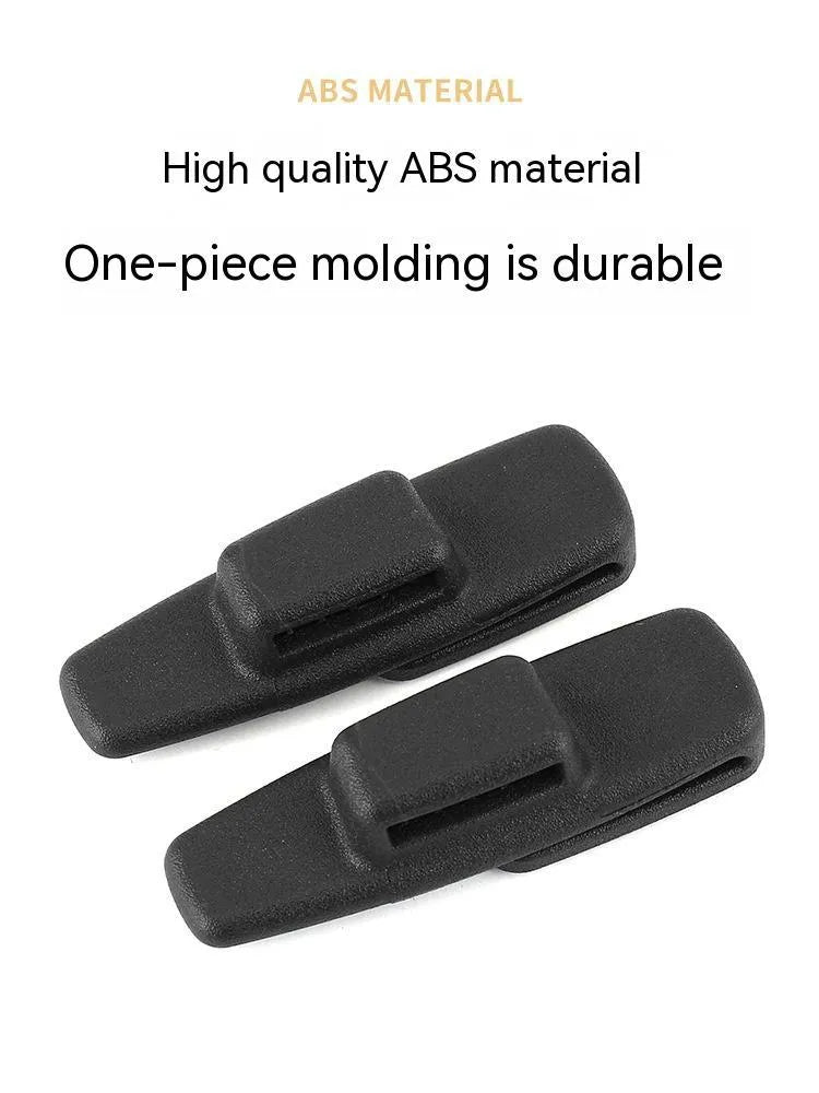 Two black ABS plastic universal car seatbelt stopper clips in clear OPP packaging