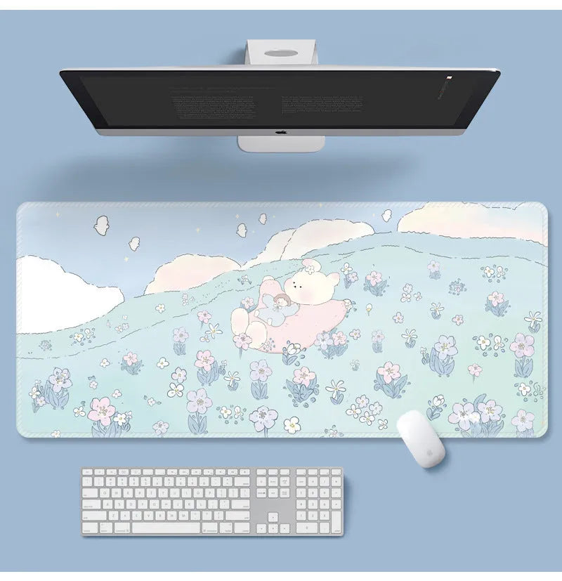 Large floral pattern mouse pad on a desk with keyboard and mouse, showing non-slip rubber base.