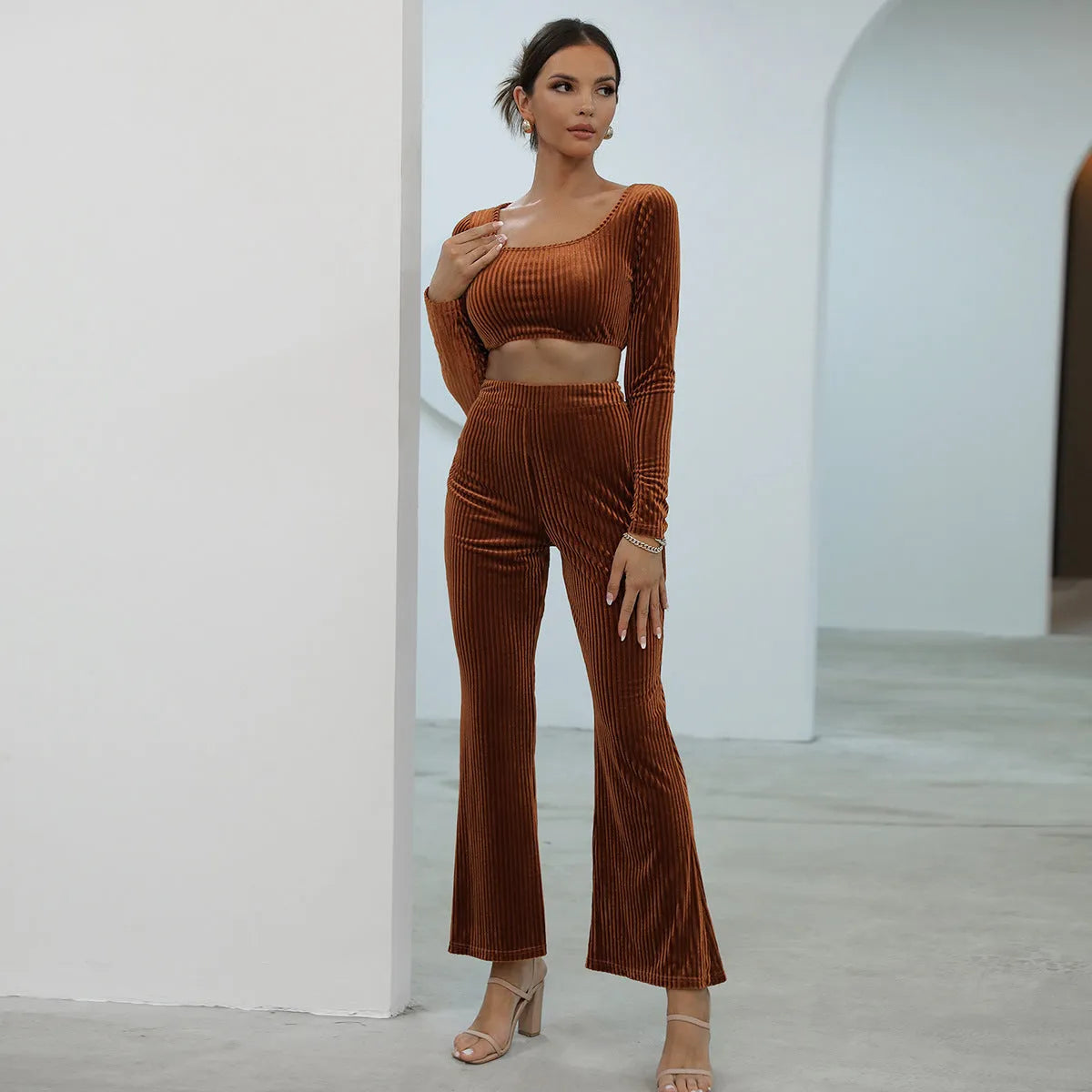 Caramel coloured women's long sleeve sweater and loose trouser co-ord set on a hanger