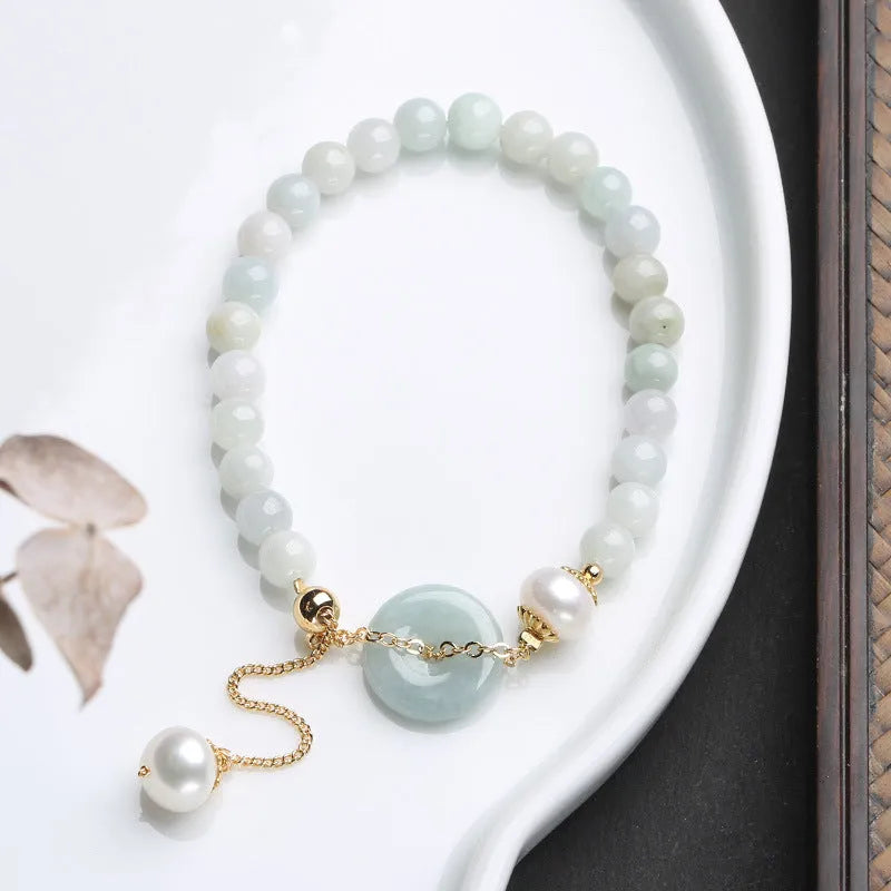 Natural jade bracelet with peace buckle fastener and white pearl accents, geometric pendant design