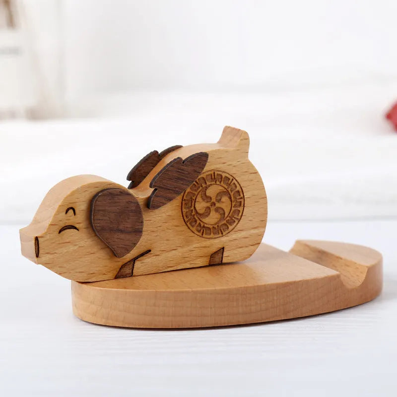 Decorative resin mobile phone stand in a choice of styles including animal figures and wood-effect designs.