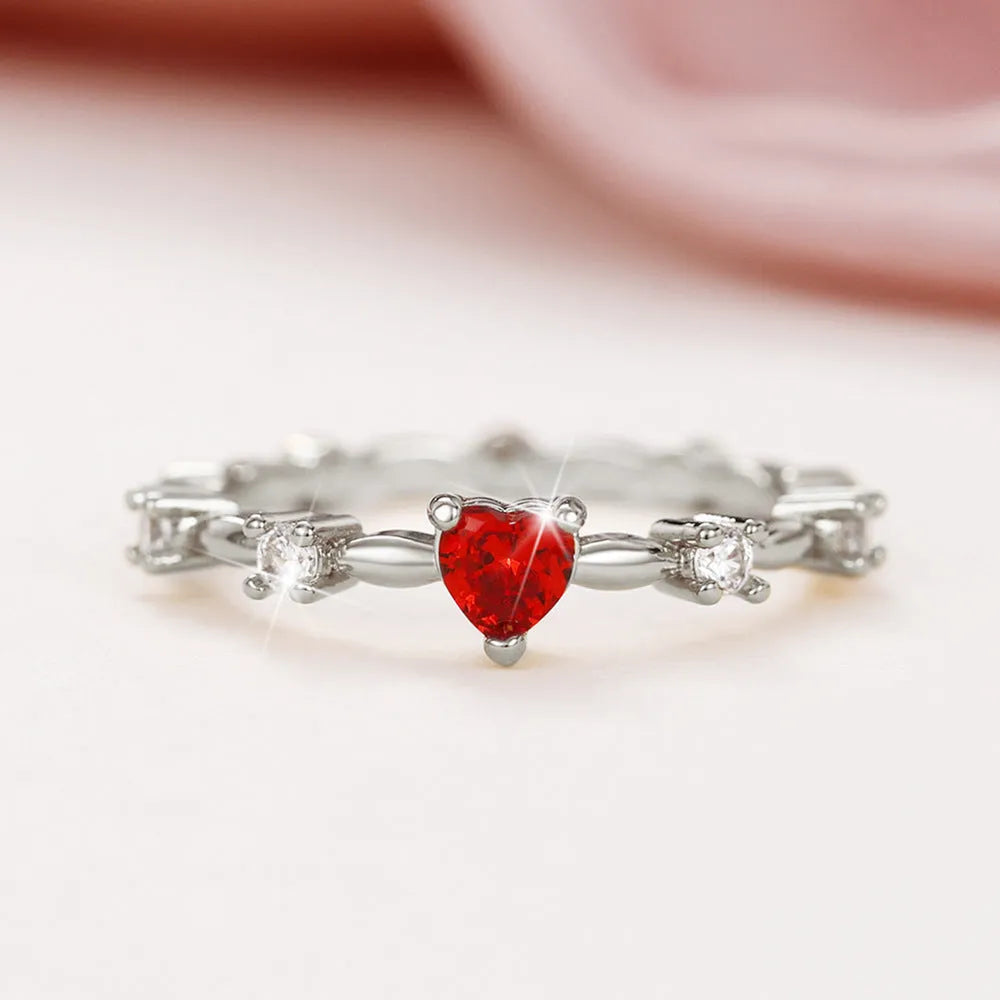 Personalised zircon peach heart ring in gold or silver finish on a copper band.